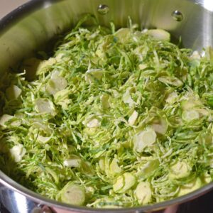 Shredded brussels sprouts in a saute pan.