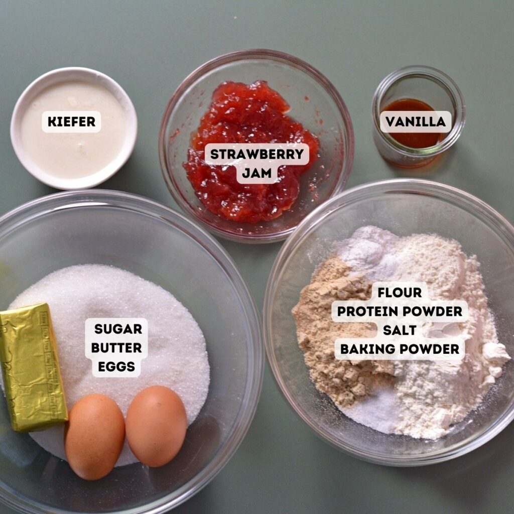 Ingredients for the cupcakes including butter, sugar, eggs, vanilla, flour, protein powder, salt, baking powder, and strawberry jam.