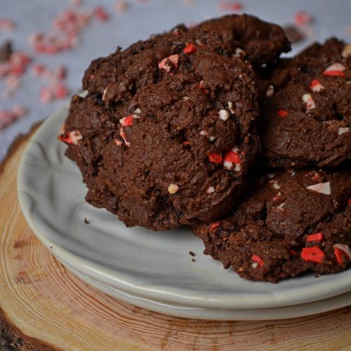 A pile of chocolate and peppermint cookies in a pile on a white plate.