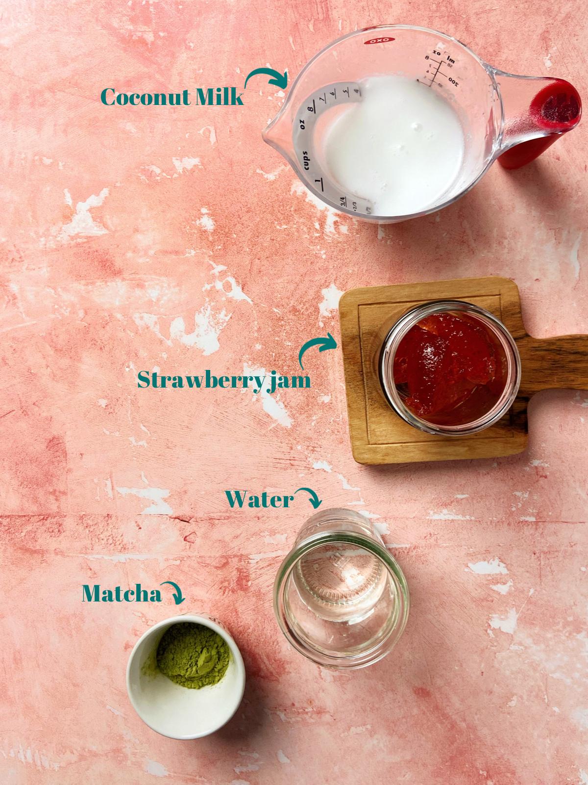 Strawberry Matcha Latte Ingredients on a red table