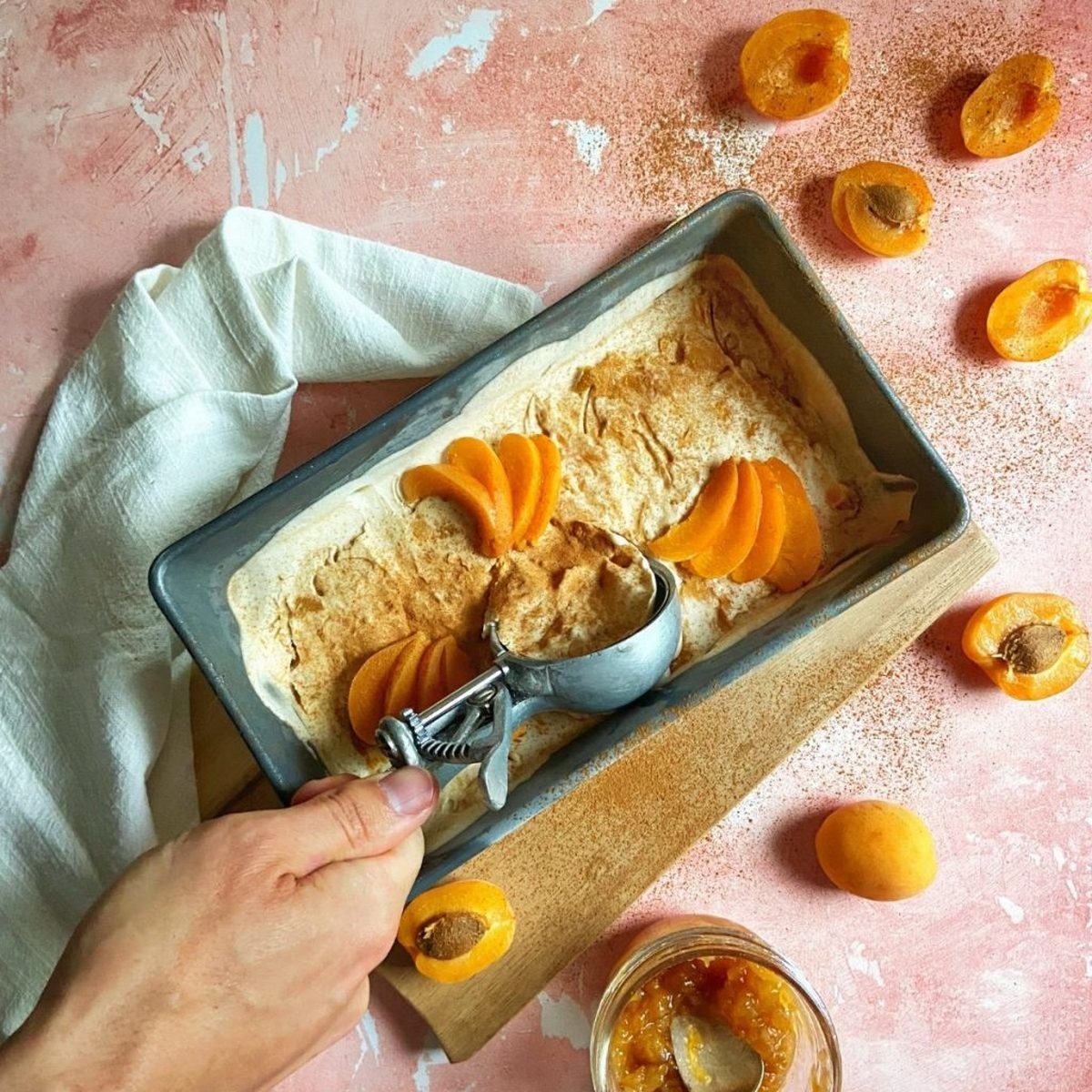 Vanilla ice cream in a bread tin with cinnamon and apricots on top.