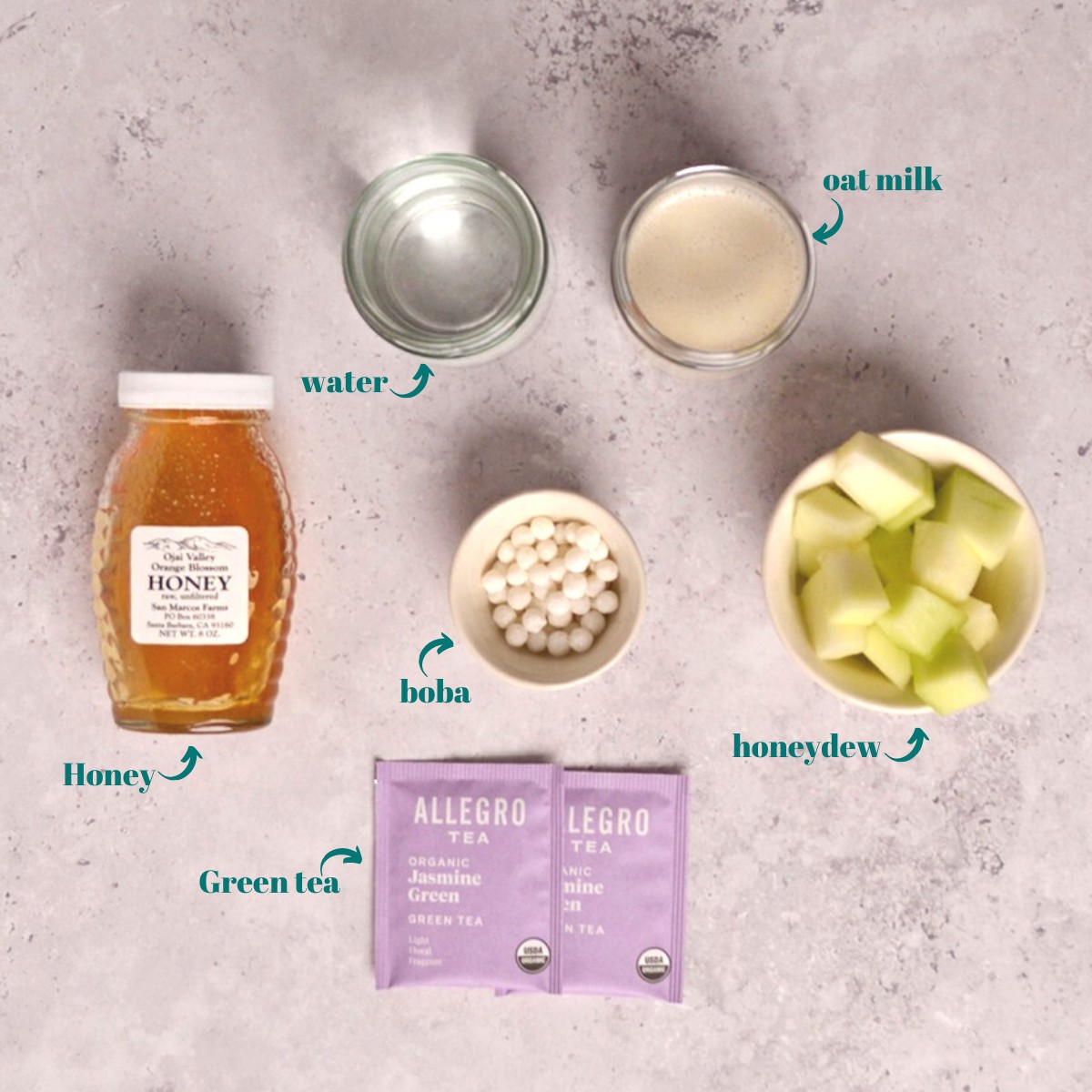 Overhead view of honeydew, boba pearls, and tea ingredients.