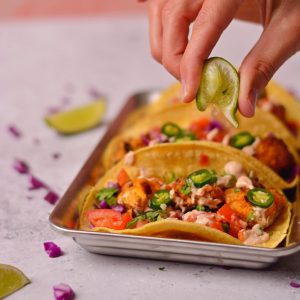 Squeezing a lime onto a taco.