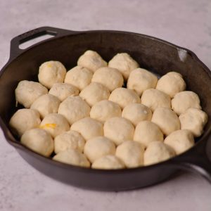 Biscuit dough in a cast iron skillet.