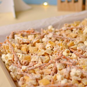 A sheet pan full of white chocolate chex mix.