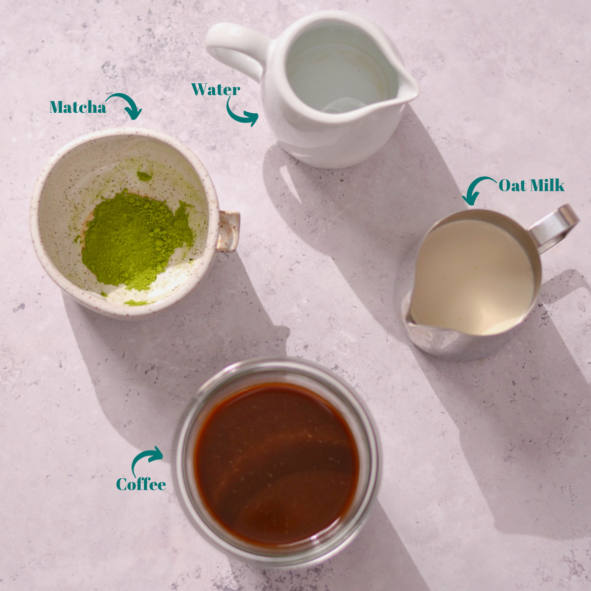 ingredients for matcha coffee latte including matcha, water, coffee, and milk.