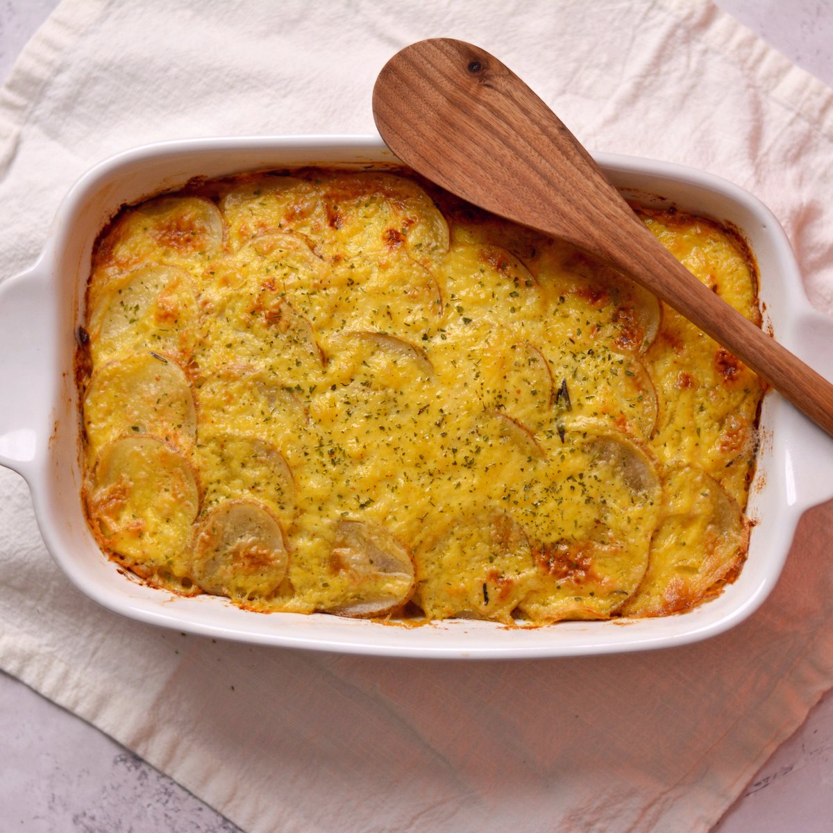 Scalloped potatoes without cream in a white casserole dish.