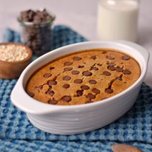 Cookie baked oatmeal with chocolate chips in a white casserole dish.
