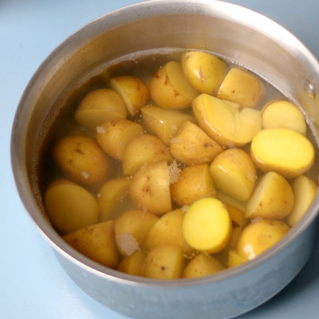 A pot of water with potatoes in it.