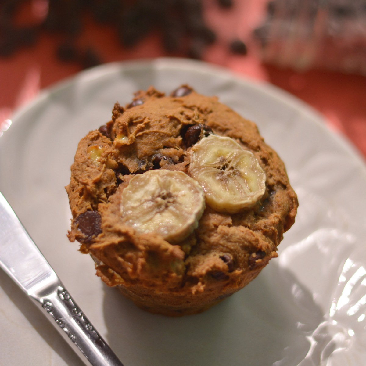 Muffin with two banana slices on top.