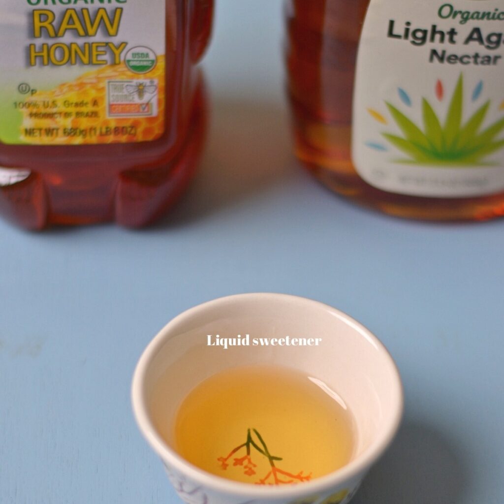 A small bowl with honey inside.