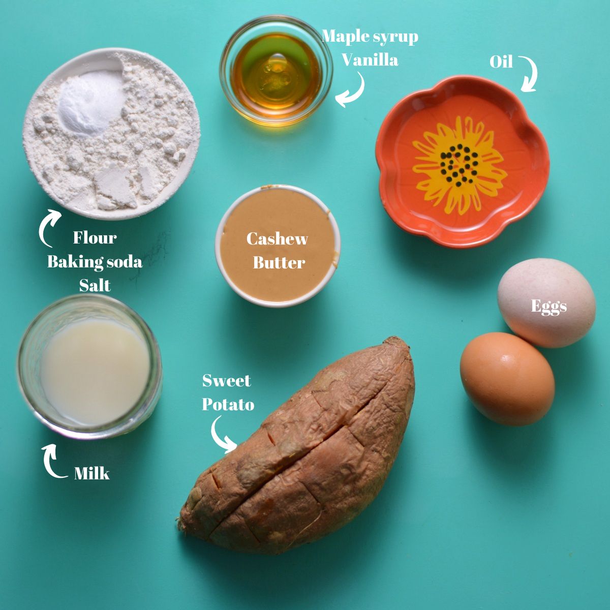 Ingredients for sweet potato waffles including sweet potato, cashew butter, milk, flour, baking soda, salt, oil, maple syrup, vanilla, and eggs.