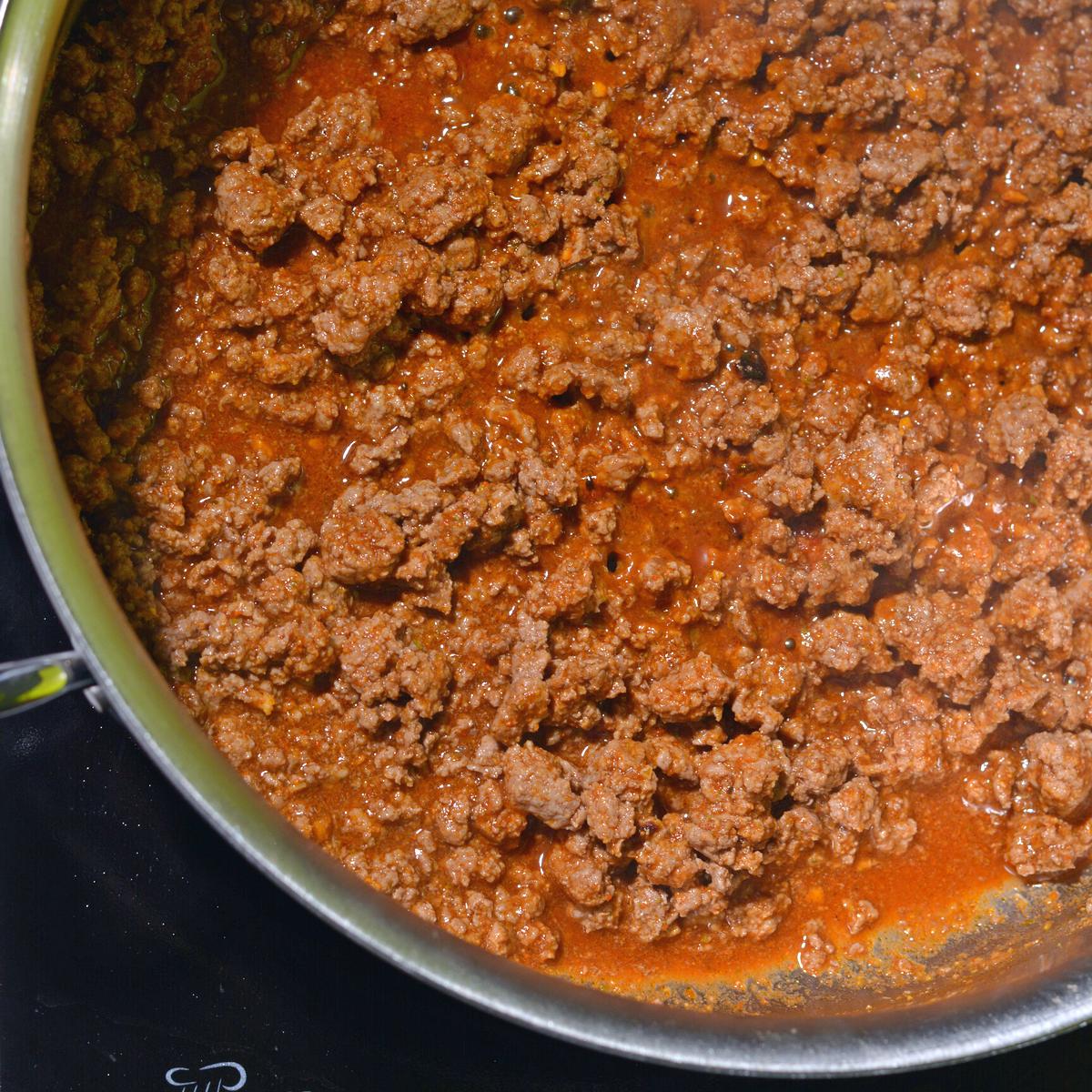 Bison taco meat with the sauce in a pan.