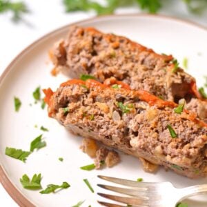 Two slices of bison meatloaf on a plate.