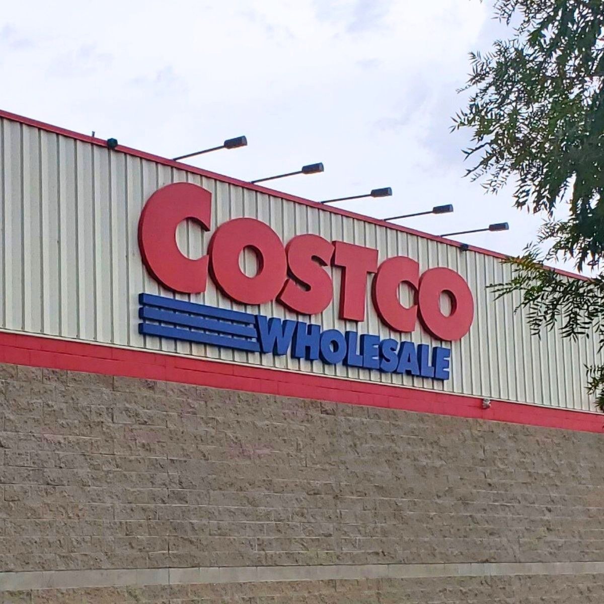 A picture of the costco sign on a store wall.
