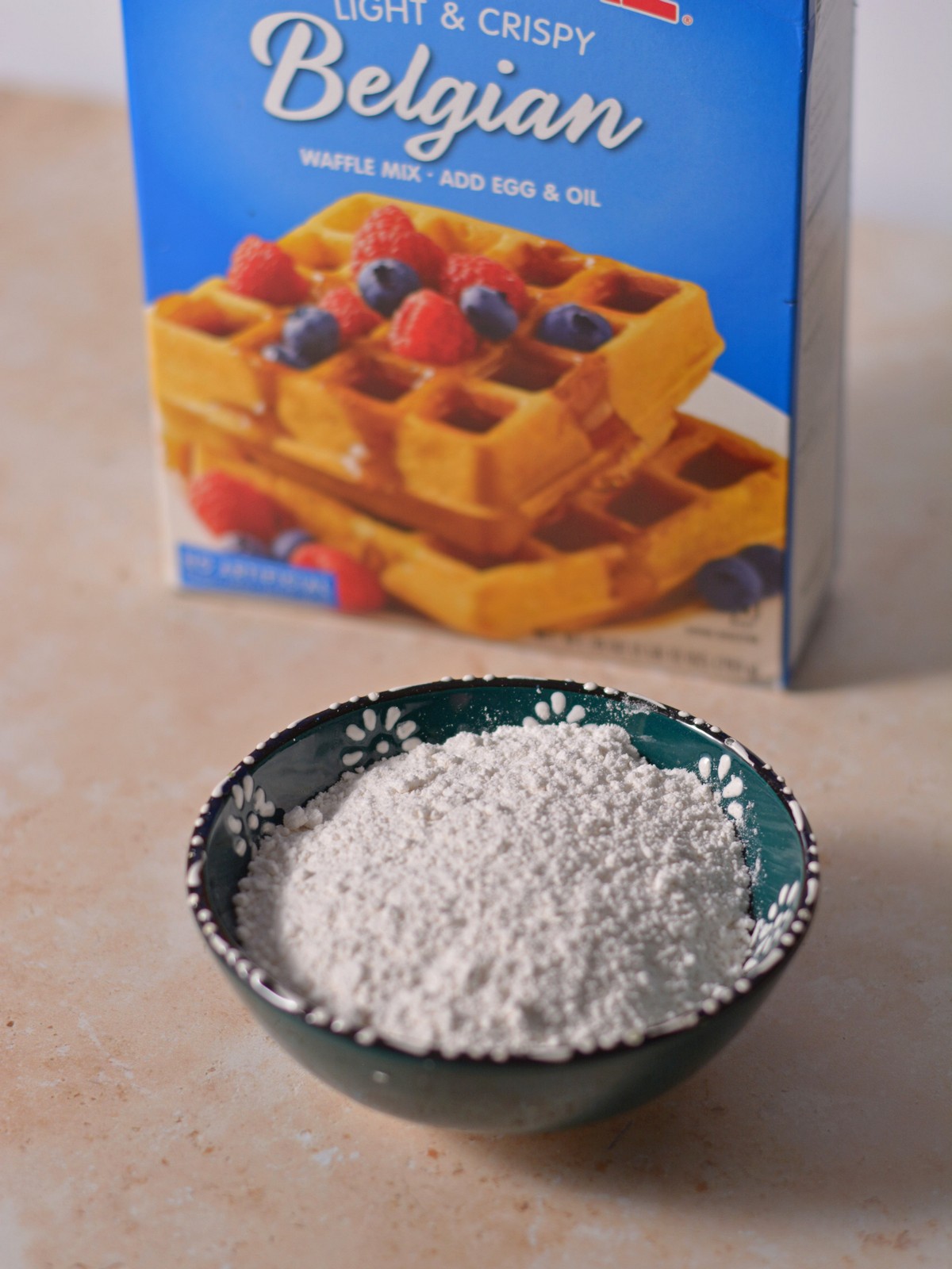 A bowl of pancake mix next to the box.