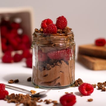 Brownie batter high protein yogurt parfait with raspberries.