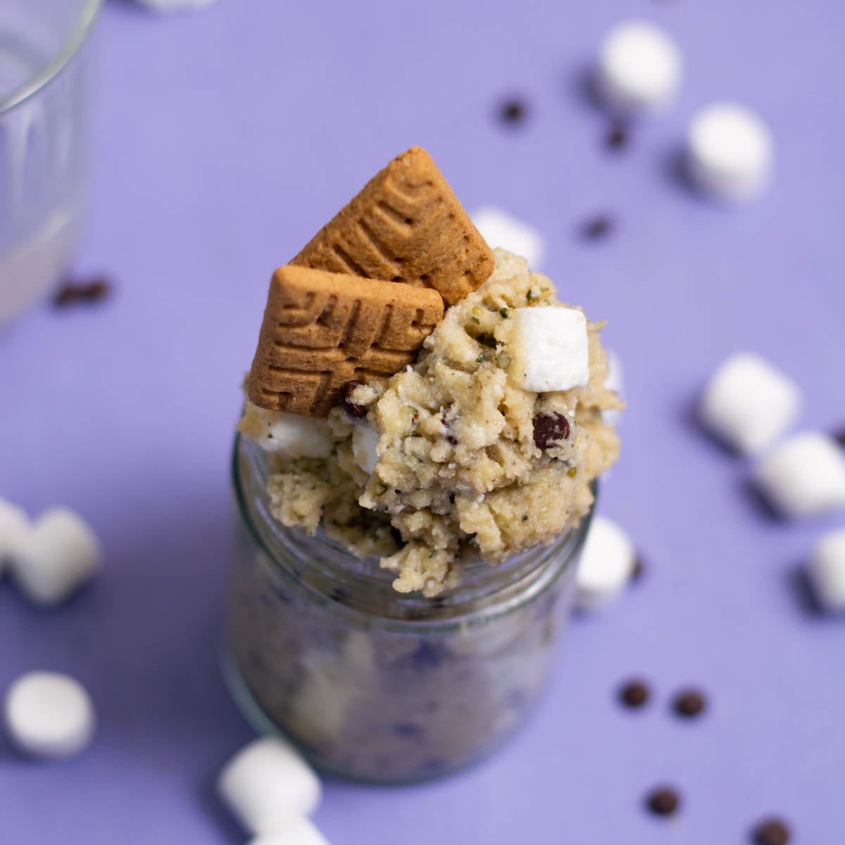 smores cottage cheese cookie dough on a purple background with marshmallows around it.