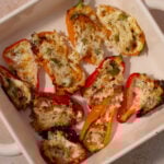 Cottage cheese stuffed peppers in a baking dish.