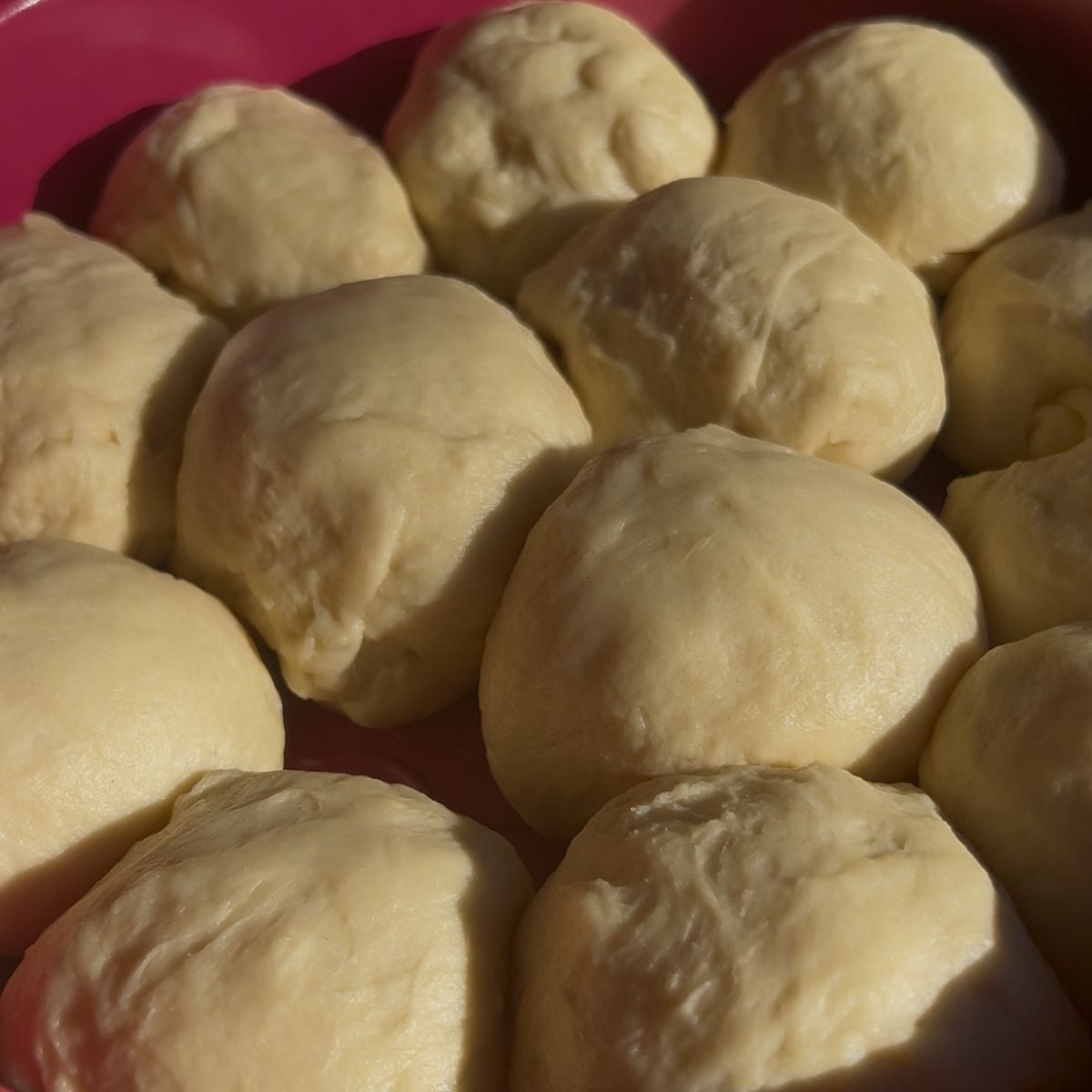 High protein dinner rolls in a pan before baking.
