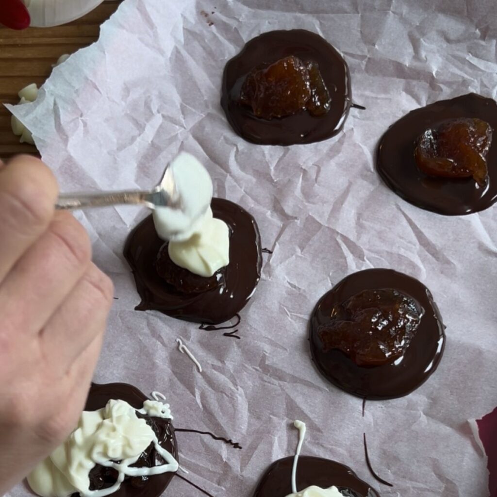 Add white chocolate on top of the chocolate and jam.