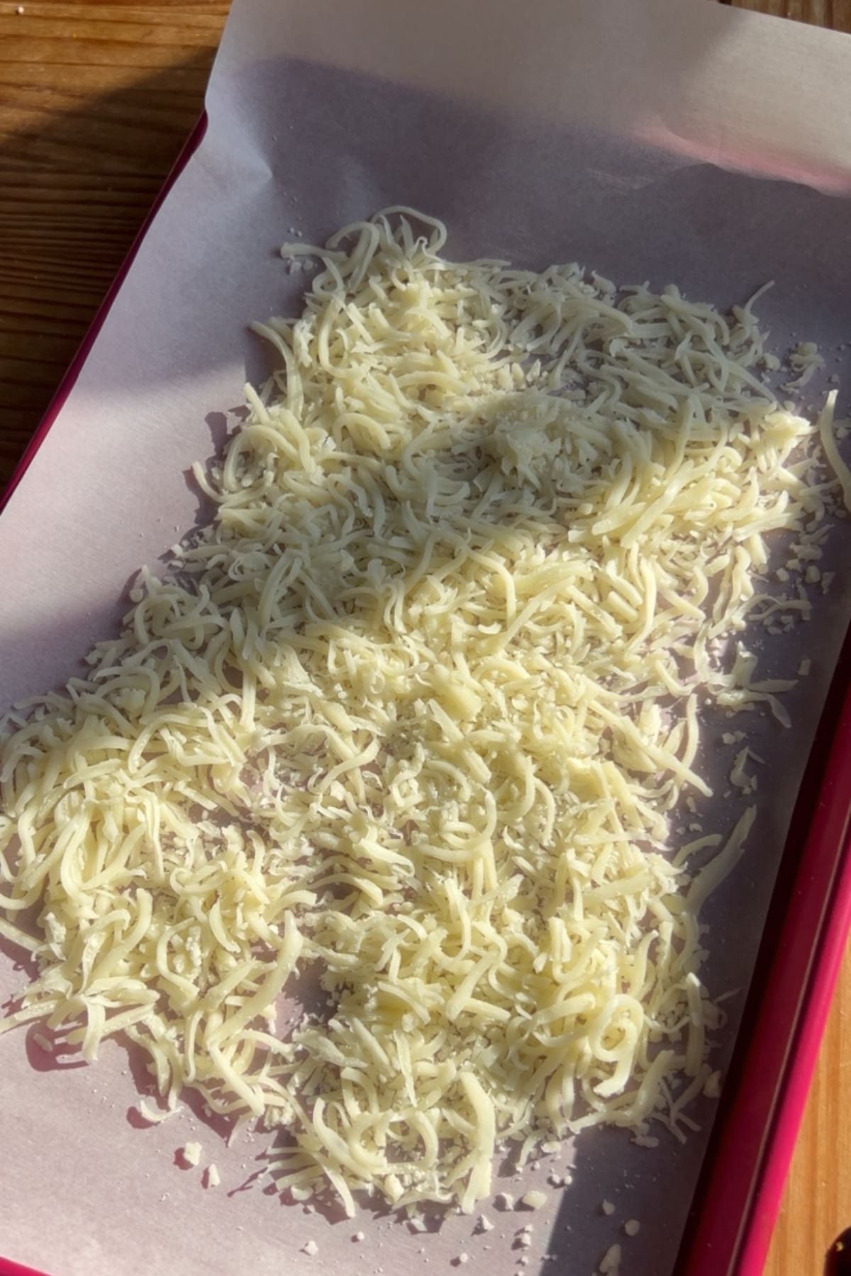 A sheet tray with mozzarella spread into a rectangle.