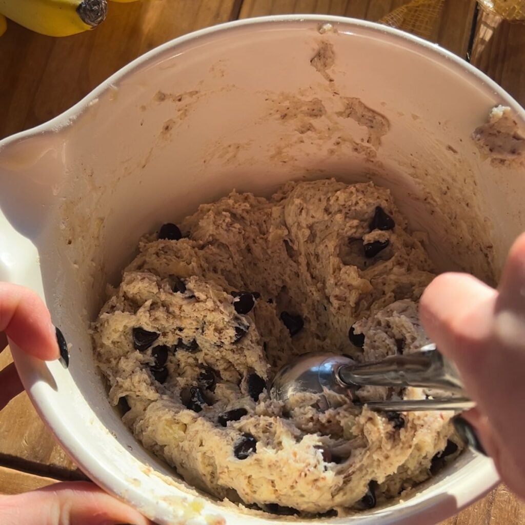 A bowl with banana bread batter in it.
