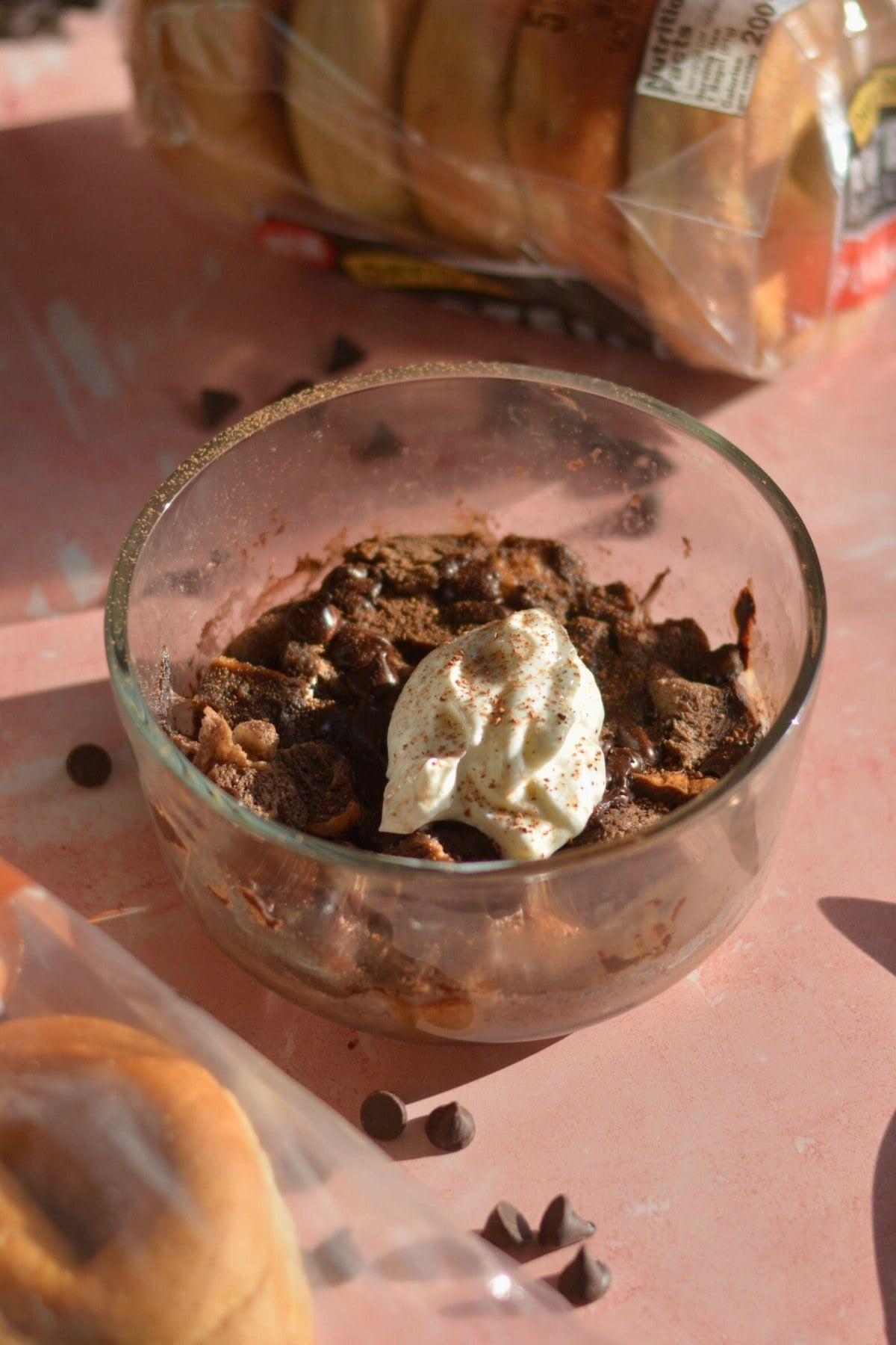 A bowl of high protein chocolate bread pudding with yogurt on top.