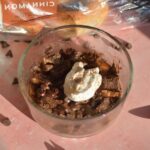 A bowl of high protein chocolate bread pudding with yogurt on top.
