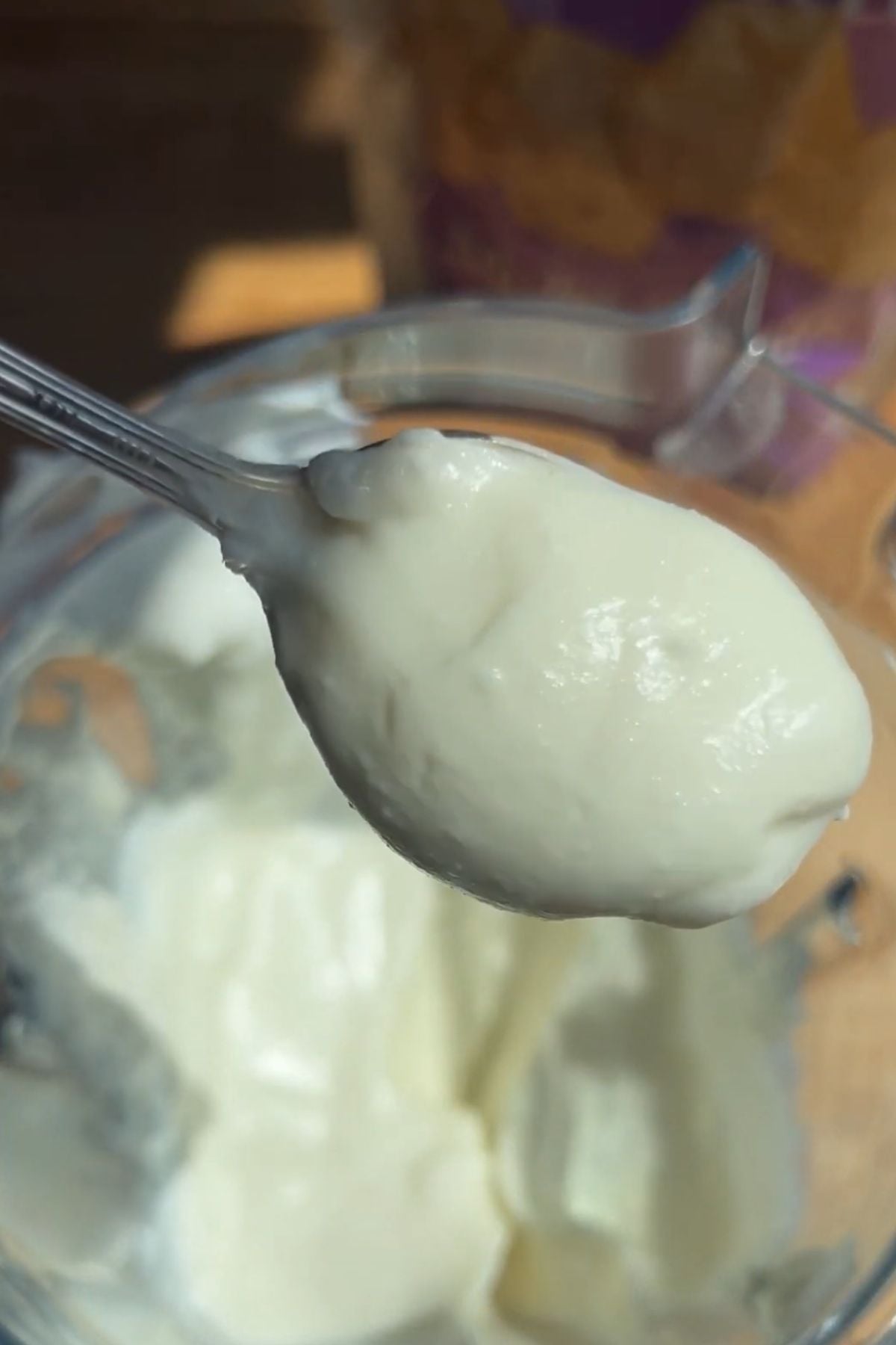 A spoon holding the dip out of the blender.