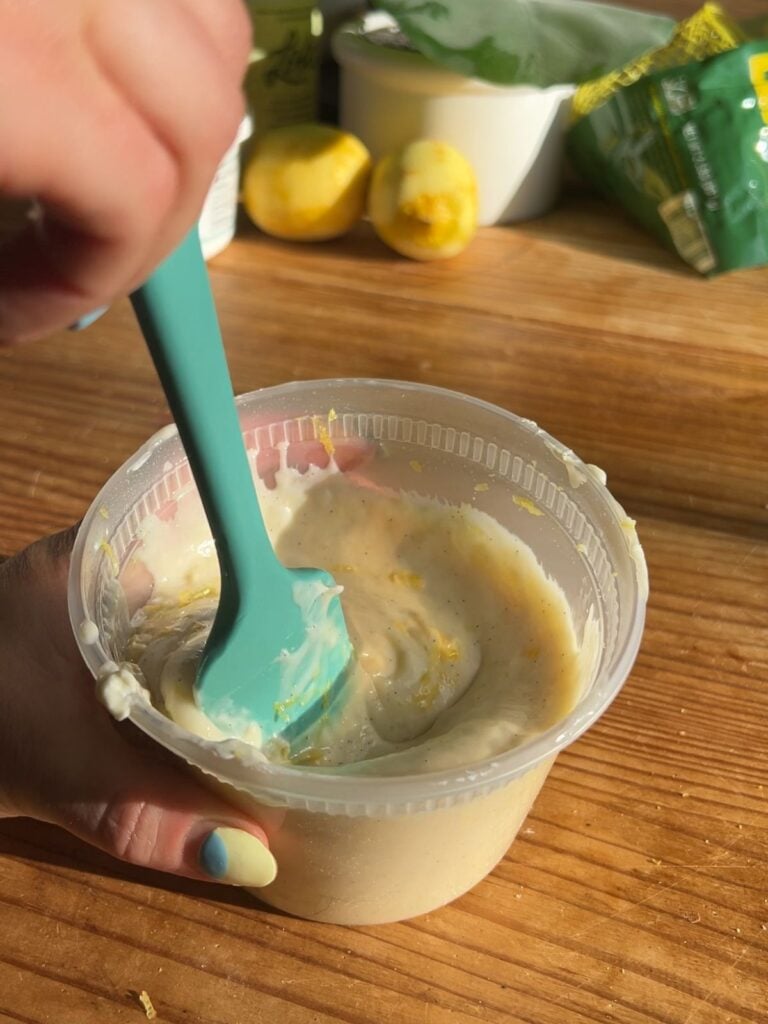 Mixing cinnamon roll frosting.