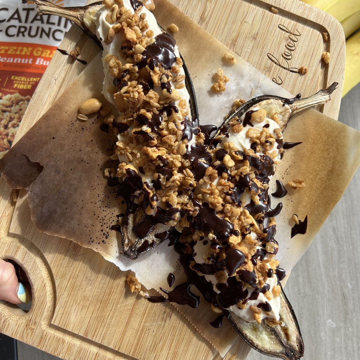 Air fryer banana split on a cutting board.