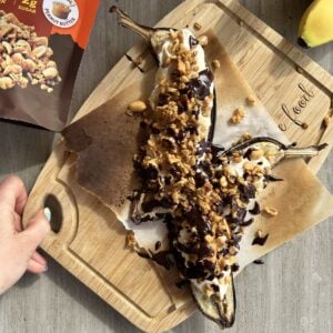 Air fryer banana split on a cutting board.
