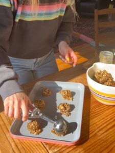 Person scooping out the cookie dough.