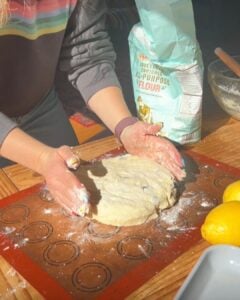 Shaping a scone circle before cutting the dough.