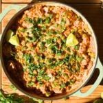 A braiser pan with curry chicken and rice.