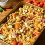High-protein pasta salad with tomatoes, mozzarella pearls, salami, and chickpeas.