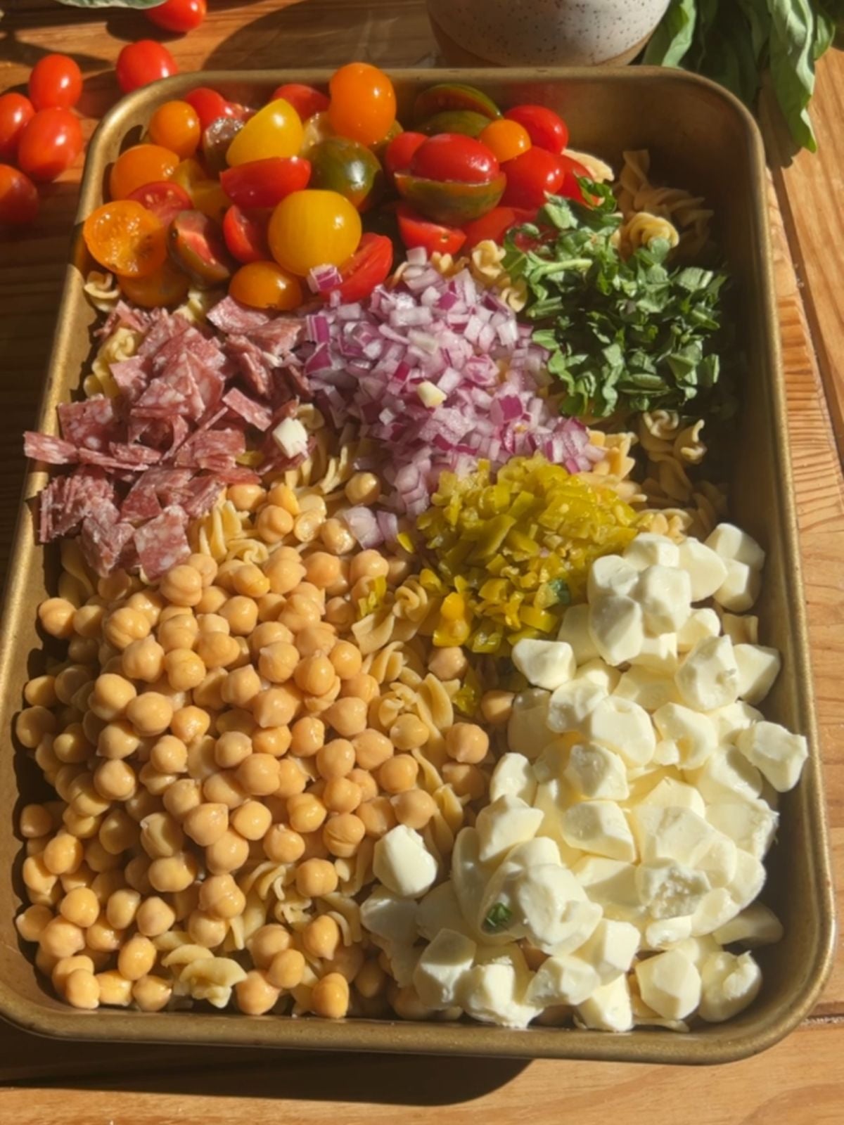 a casserole dish filled with high protein pasta salad ingredients.