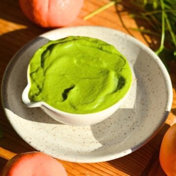 A bowl of bright green high protein avocado sauce.