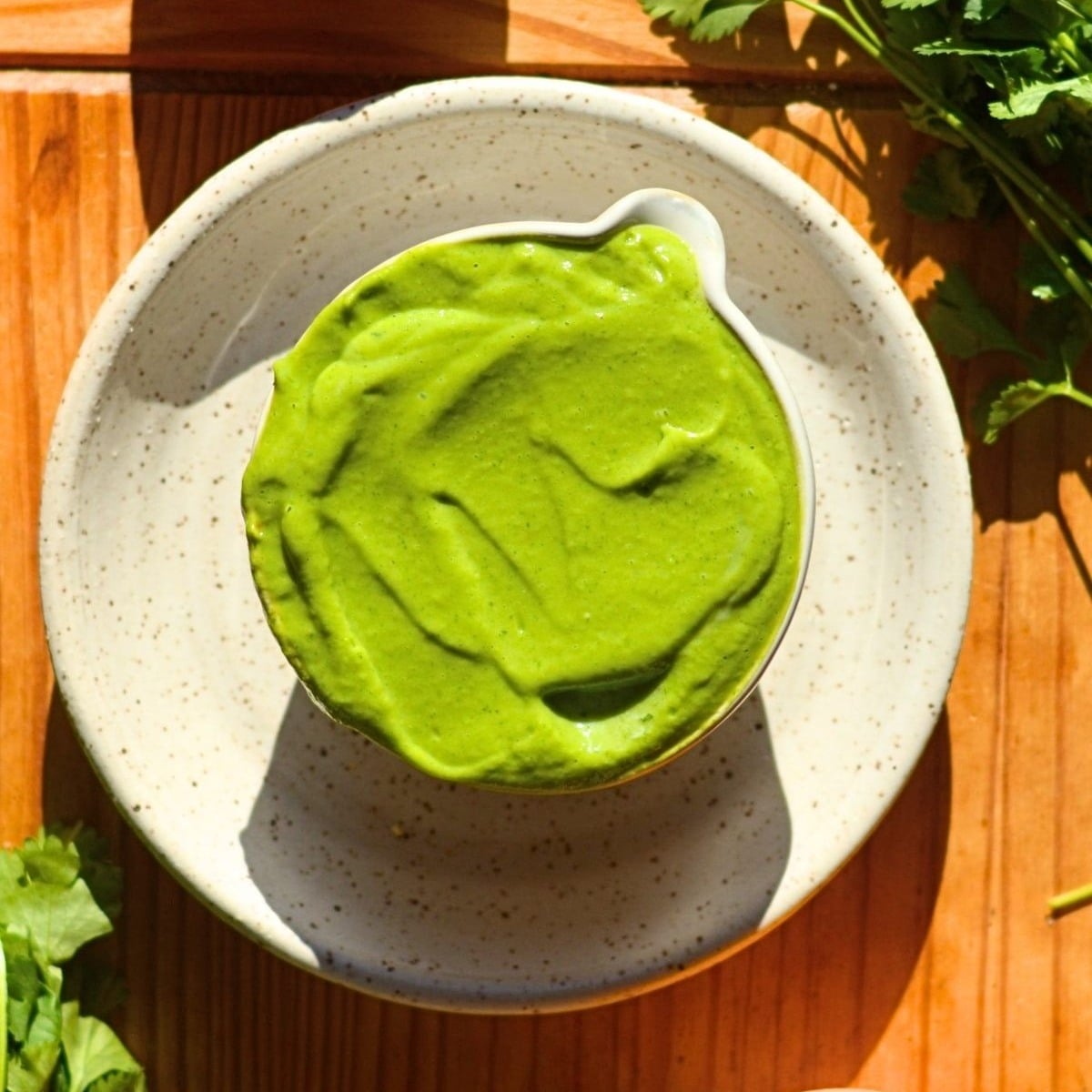 A bowl of bright green high protein avocado sauce.
