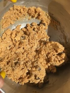A bowl showing the texture of the peanut butter protein balls dough.