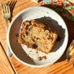 A slice of brown butter protein banana bread on a white plate.