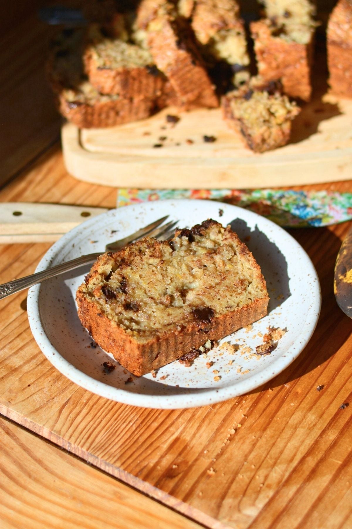 A slice of brown butter protein banana bread on a white plate.