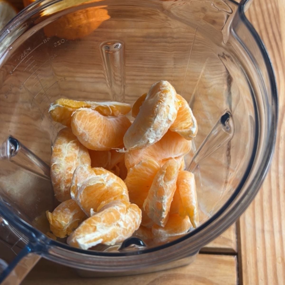 a blender with frozen orange slices.