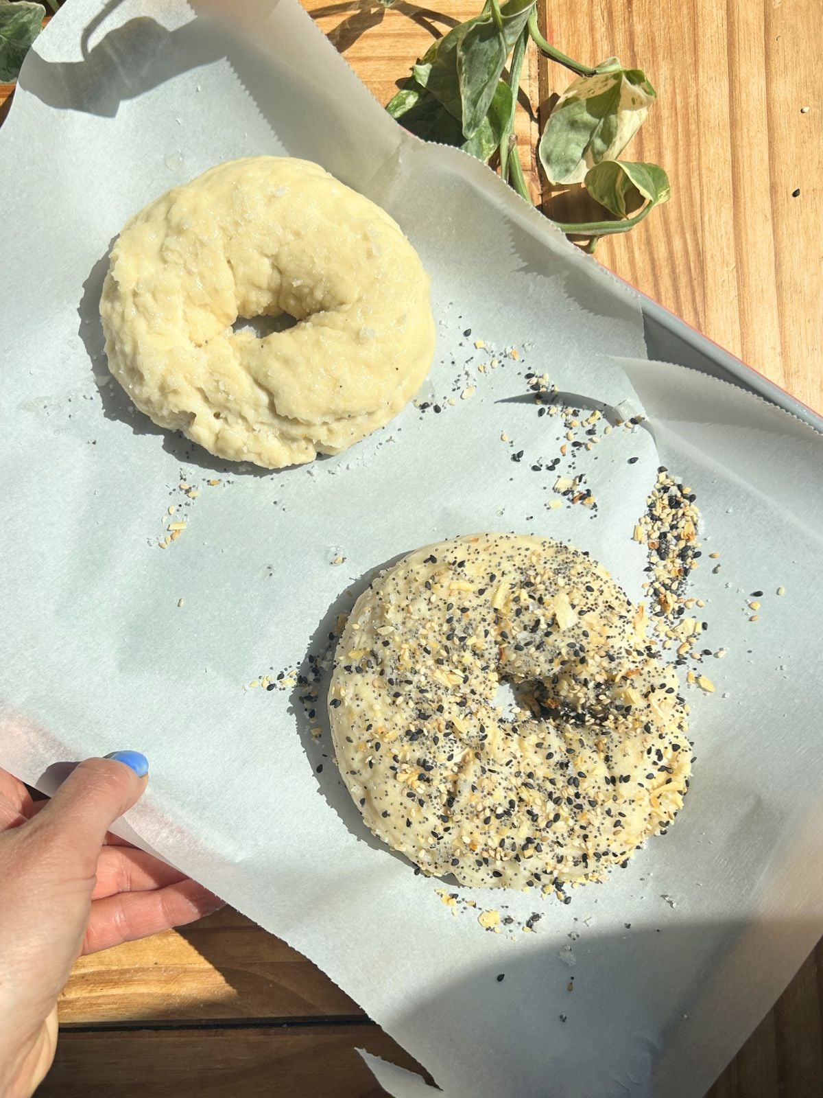 A tray with two cottage cheese bagels before baking.