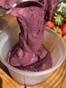 Protein acai being poured into a container.