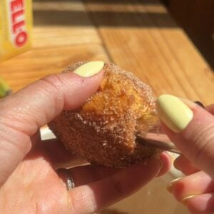 Using a piping tip to pock a hole int he donut side for filling.