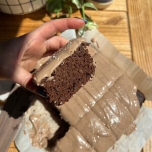 Hand holding the chocolate cake.