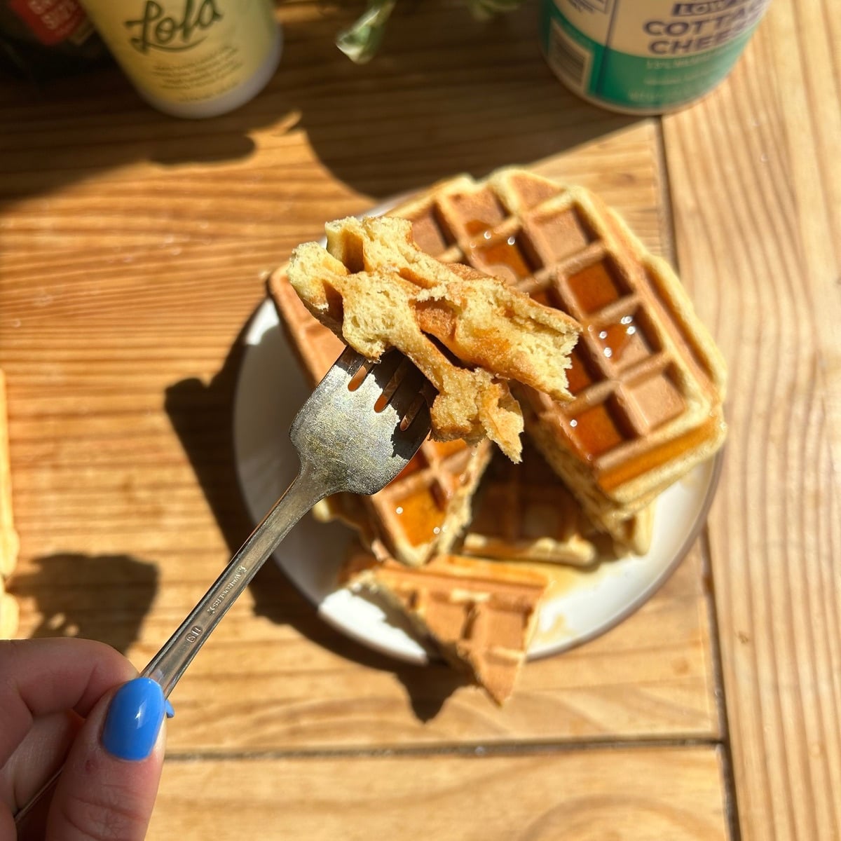 A fork holding cut up cottage cheese waffles.