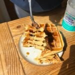 A fork holding cut up cottage cheese waffles.